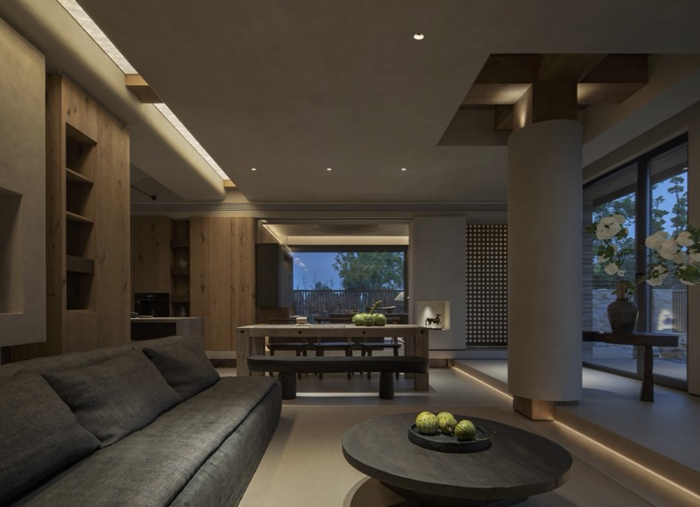Private residence at dusk — warm cove lighting across the living and dining space.