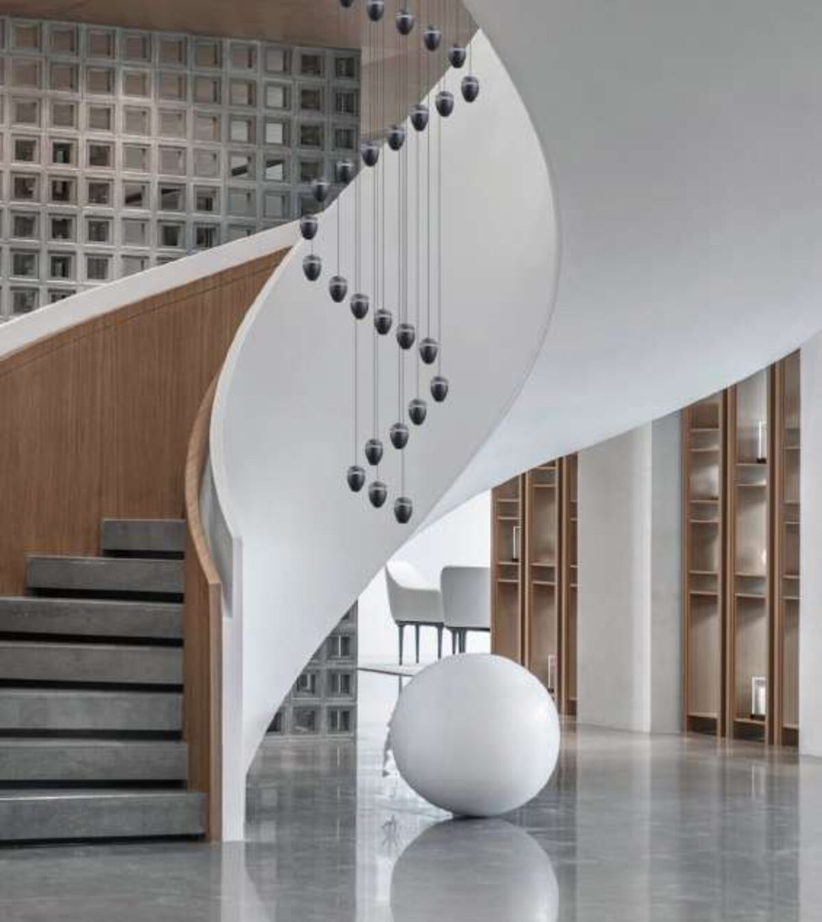 Cascading pendant installation over a spiral staircase.